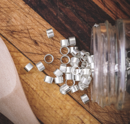 Sterling silver tube bezel setting spilled on to tabletop